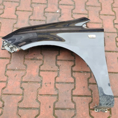 Błotnik przód przedni lewy czarny Opel Corsa D